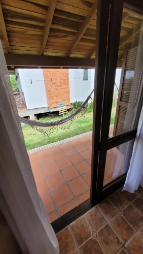an open door with a view of a patio at Pousada Capitão Cook in Praia do Rosa