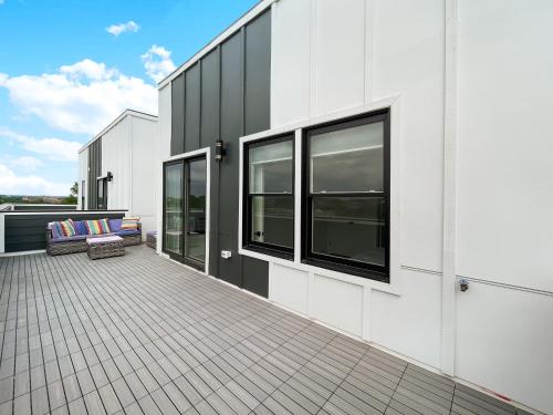 a balcony of a white building with a couch at Mary's Stay Brookland in Washington