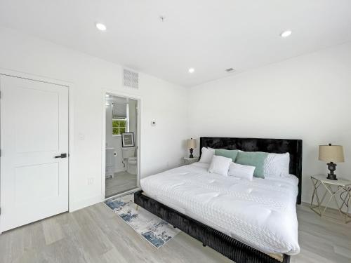 a white bedroom with a bed and a bathroom at Mary's Stay Brookland in Washington