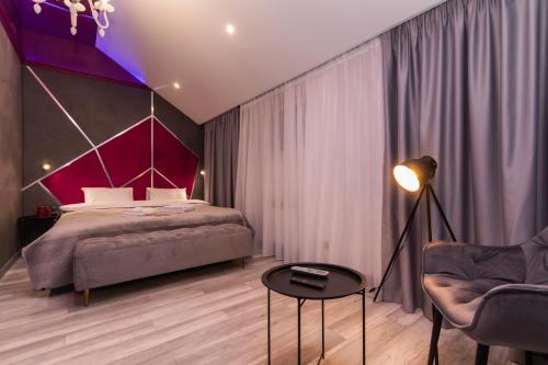 a bedroom with a bed and a chair at LUX Апартаменти MYFREEDOM поруч метро Театральна, Хрещатик in Kyiv