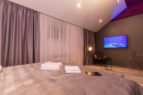 a bedroom with a large bed with two towels on it at LUX Апартаменти MYFREEDOM поруч метро Театральна, Хрещатик in Kyiv