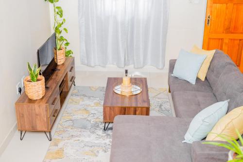 ein Wohnzimmer mit einem Sofa und einem Tisch in der Unterkunft Davi Bliss in Oshakati