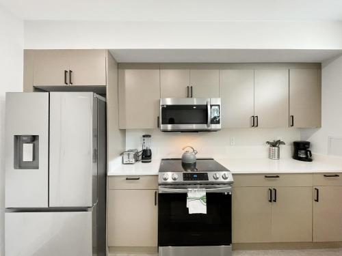 a kitchen with a stove and a microwave at Mary's Stay Brookland in Washington
