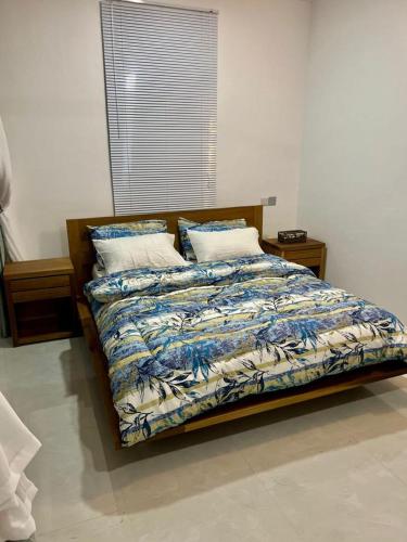 a bedroom with a bed with a quilt and pillows at OV HOMES in Dar es Salaam