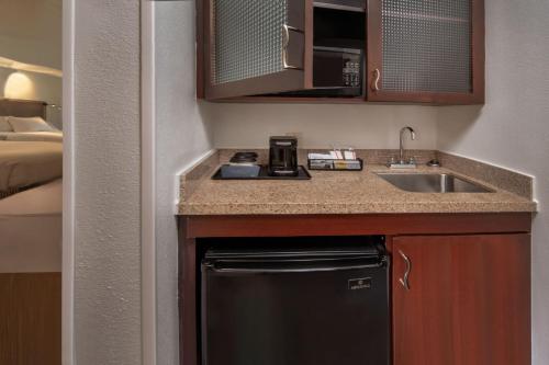 a small kitchen with a sink and a dishwasher at SpringHill Suites Hagerstown in Hagerstown