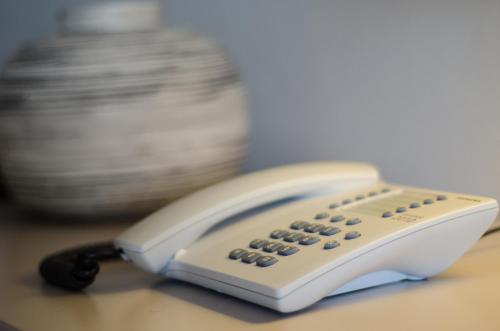 a white phone sitting on top of a table at Plaka Studios in Karfas