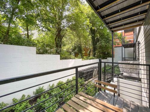 a balcony of a house with a wooden bench at Mary's Stay Brookland in Washington