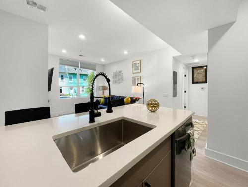 a kitchen with a sink and a counter top at Mary's Stay Brookland in Washington