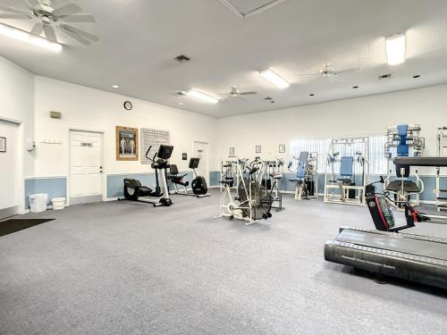 a gym with treadmills and machines in a room at Beautifully updated bright and cheery 2nd story condo near pool beach access- SC261 in Edgewater