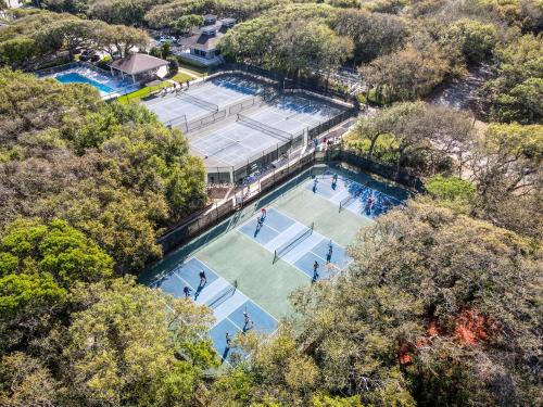 an overhead view of two tennis courts with people on them at Beautifully updated bright and cheery 2nd story condo near pool beach access- SC261 in Edgewater