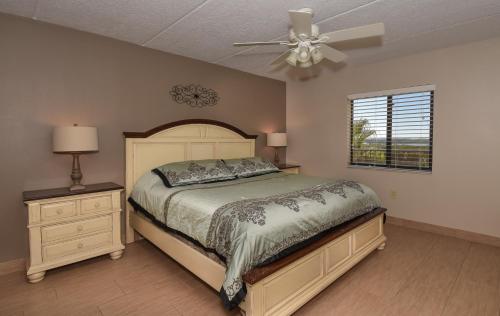 a bedroom with a bed and a ceiling fan at Floor-to-Ceiling Oceanfront Views ~ Chadham-by-the-Sea 315 in New Smyrna Beach