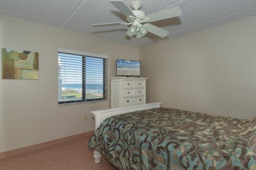 a bedroom with a bed and a ceiling fan at Floor-to-Ceiling Oceanfront Views ~ Chadham-by-the-Sea 315 in New Smyrna Beach