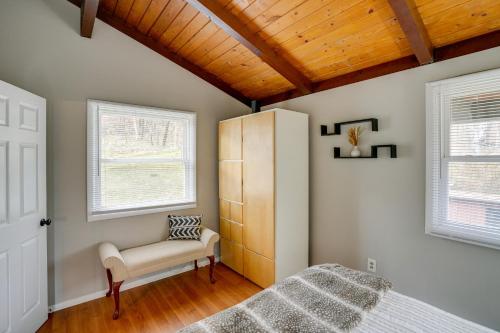 ein Schlafzimmer mit einem Bett, einem Schrank und zwei Fenstern in der Unterkunft Hunter Mountain Home Less Than 1 Mi to Ski Resort! in Hunter