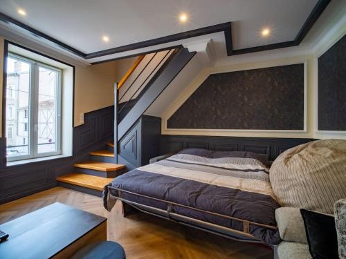 une chambre avec un grand lit et un escalier dans l'établissement Méga Jeanne d'Arc Billard Baby Foot Logements Insolites, à Nancy