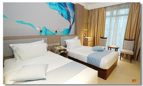 a hotel room with two beds and a room at pristine 1 in Manila