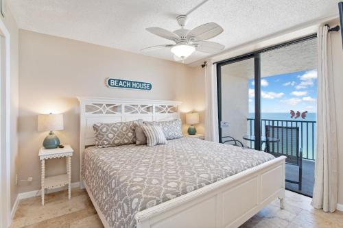 a bedroom with a bed and a balcony at Beachfront 2 Bed at Popular Seawinds!!! in Marco Island