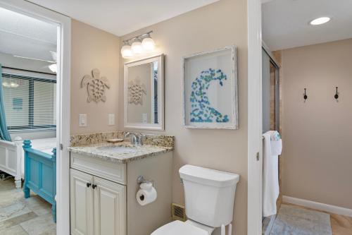 a bathroom with a toilet and a sink at Beachfront 2 Bed at Popular Seawinds!!! in Marco Island