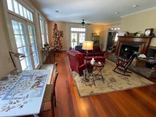 a living room with a christmas tree and a fireplace at Historic Seaton Springs Farm B&B - James Tipton En-Suite Triple Room in Sevierville