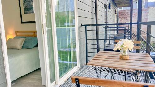 a porch with a wooden bench and a vase of flowers at Mary's Stay Brookland in Washington