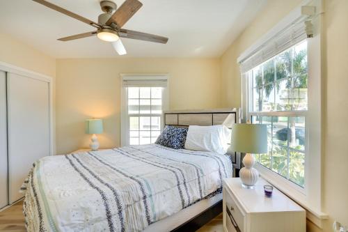 a bedroom with a bed with a ceiling fan and a window at Huntington Beach Hideaway Near Beach and Downtown! in Huntington Beach