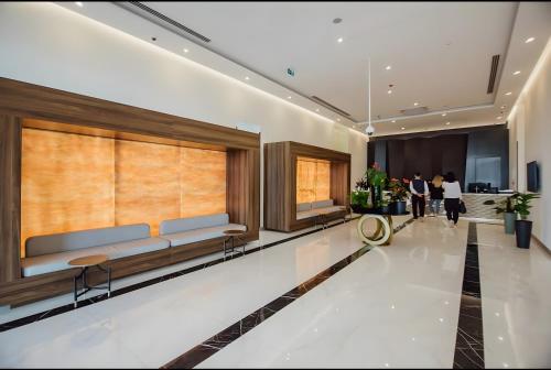 a lobby of a hotel with people walking in it at PANORAMA Orbi Beach Resort Center Suite in Batumi