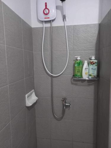 a shower in a bathroom with a shower head at 6F Balcony View Studio Mesatierra Garden Residences in Davao City
