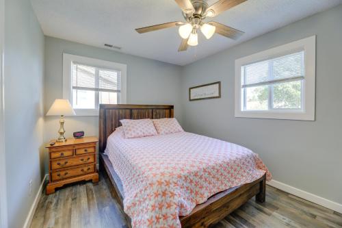 a bedroom with a bed and a ceiling fan at New Bern Abode with Yard about 2 Mi to Neuse River in New Bern