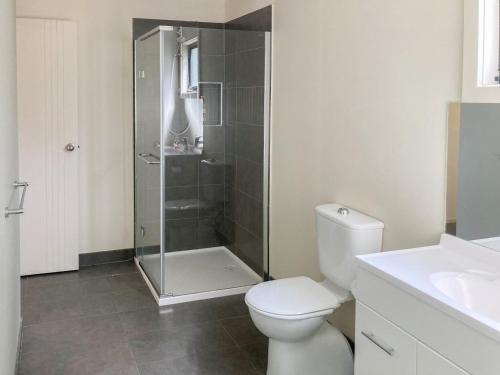 a bathroom with a shower and a toilet and a sink at Eildon Views in Bonnie Doon