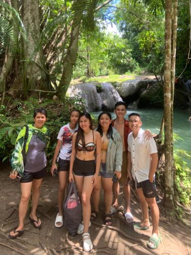 a group of people standing in front of a river at Chekesh Casa in Siquijor