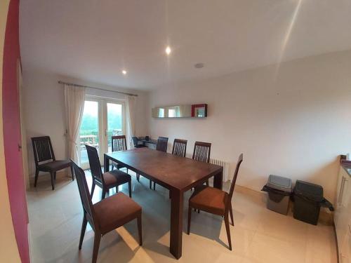 a dining room with a wooden table and chairs at Beautiful Holiday Cottage near Kenmare in Kenmare