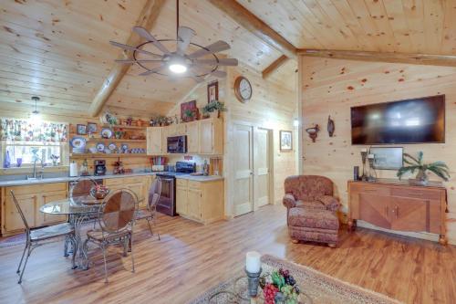 a dining room and kitchen in a log cabin at Tumbling Shoals Cabin with Fire Pit 1 Mi to Lake in Heber Springs