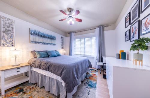 a bedroom with a bed and a desk and a ceiling fan at Cityscape Haven - Central SF Home near SFO in San Bruno