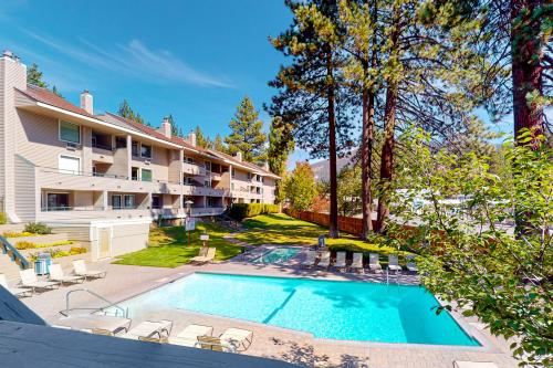 a swimming pool in a yard next to a building at Lakeland Village South Lake Tahoe in South Lake Tahoe