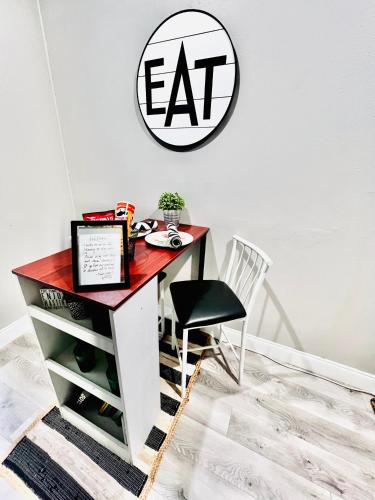 a desk with a chair and a sign on a wall at Paradise Hideaway Entire guest home near beach in Clearwater