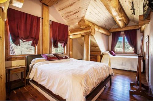 a bedroom with a bed in a room with wooden ceilings at South Fork Sanctuary in South Fork