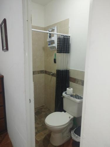 a bathroom with a toilet and a shower at Mini Suite in Manta