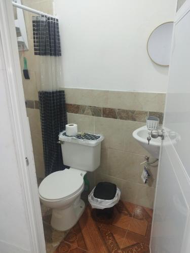 a bathroom with a toilet and a sink at Mini Suite in Manta
