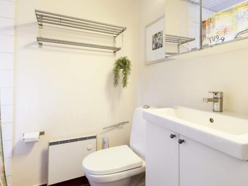 een witte badkamer met een toilet en een wastafel bij Holiday home Ærøskøbing XI in Ærøskøbing