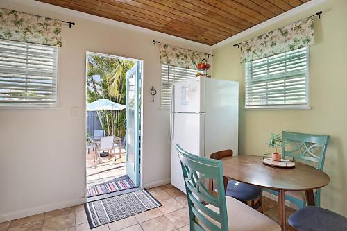a kitchen with a table and a refrigerator at Steps to Beach & Downtown! Cozy Beach Bungalow #4 in Lake Worth
