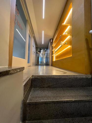 a hallway of a building with stairs and a door at STUDIO 304 | WIFI 600MB | RESIDENCIAL JC, um lugar para ficar. in Belém
