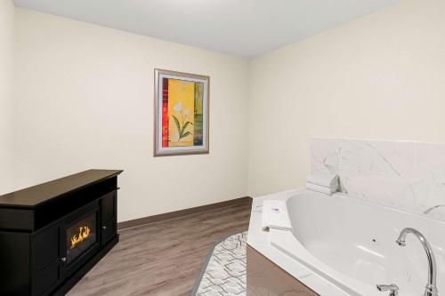a white bathroom with a bath tub and a sink at Comfort Suites Vacaville-Napa Valley Area in Vacaville