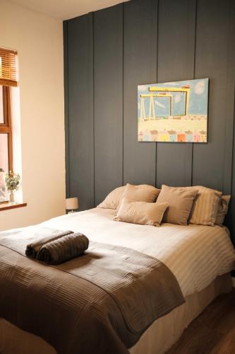 a bedroom with a large bed with a painting on the wall at Antrim Road Apartments Belfast in Belfast
