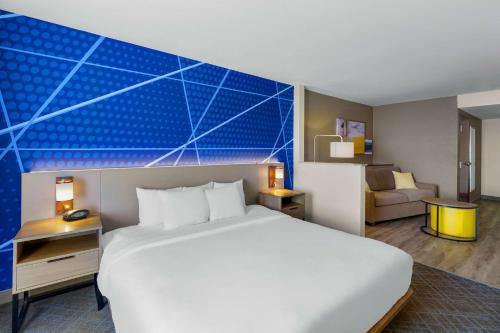 a hotel room with a large bed and a couch at Comfort Suites Vacaville-Napa Valley Area in Vacaville
