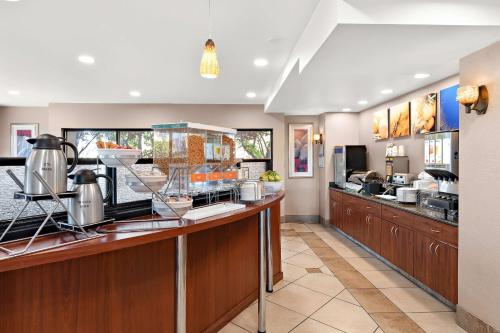 a restaurant kitchen with a counter with food at Comfort Suites Vacaville-Napa Valley Area in Vacaville