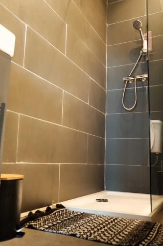 a bathroom with a shower with blue tiles at Antrim Road Apartments Belfast in Belfast