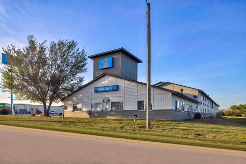 a building with a sign on the side of it at Motel 6 Stuart, IA in Stuart