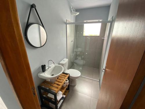 a bathroom with a sink and a toilet and a mirror at Morada Pomerode 2 in Pomerode