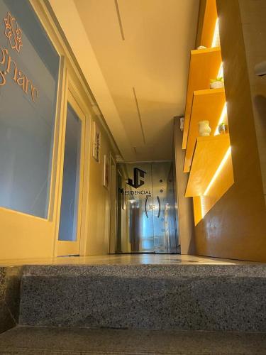 an empty hallway of a building with a refrigerator at STUDIO 204 | WIFI 600MB | RESIDENCIAL JC, um lugar para ficar. in Belém