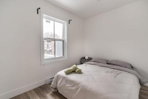 a bedroom with a bed with a teddy bear on it at Spacious 2 bedroom apartment - 02 in Montreal