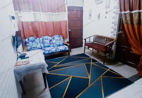 a living room with a couch and a chair at AABM HOMESTAY Ipoh in Ipoh
